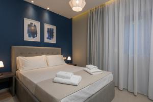 a bedroom with a bed with towels on it at Mirma City apartment2 Old Town in Chania