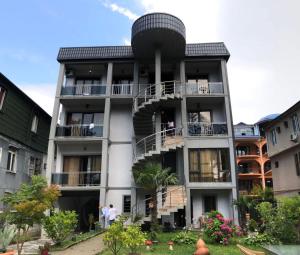 a building with a spiral staircase in front of it at SWEET HOUSE 470 in Kobuleti