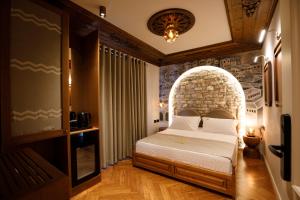 a bedroom with a bed with an arch in it at Nostalgia Boutique Hotel in Gjirokastër