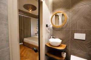 a bathroom with a sink and a mirror at Nostalgia Boutique Hotel in Gjirokastër +94 photos