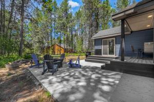 a patio with chairs and a table on a house at Ski Haus- Remodeled- Near Tamarack and Lake Cascade- pet ok in Donnelly