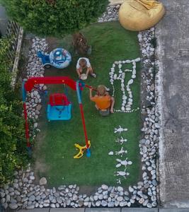 a toy park with two children playing in the grass at LuxuryHomeUlcinj2 in Ulcinj