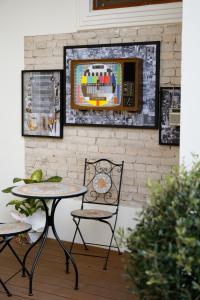 a table and chairs in front of a brick wall at Nostalgia Boutique Hotel in Gjirokastër