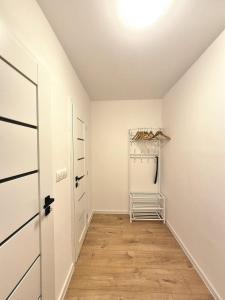a white room with a closet and a door at Krásny apartmán v Ružinove in Bratislava +7 photos