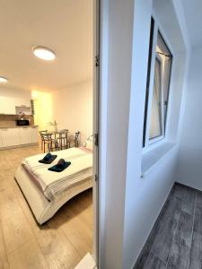 a bedroom with a bed and a table in a room at Krásny apartmán v Ružinove in Bratislava