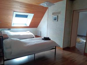 a bedroom with two beds and a window at Vauville Sunset in Vauville +9 photos