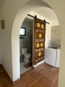 an archway leading to a bathroom with a toilet at Vila Malina in Gaberje