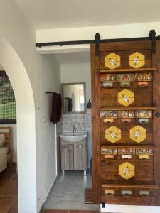 a bathroom with a wooden door with a sink at Vila Malina in Gaberje