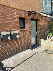 a brick building with a door and a window at Ferienwohnung Appartement am Wildpark Bad Harzburg in Bad Harzburg