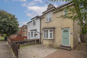 a brick house with a green door on a street at 4 BDR I sleeps 8 I Wi-FI I Free Parking I Central in CBG