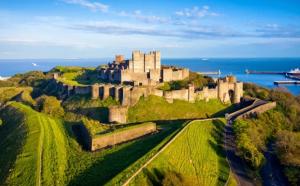 a castle on a hill with the ocean in the background at Dover Heights in Dover