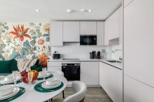 a kitchen and dining room with a table and chairs at New in Willesden close to Oxford Str, Wembley, Jubilee line in London