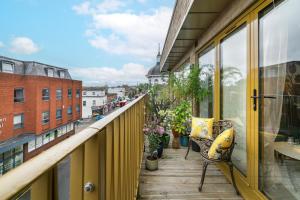a balcony with chairs and a view of a city at New in Willesden close to Oxford Str, Wembley, Jubilee line in London