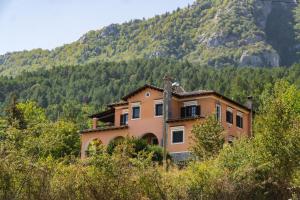 a house in the middle of a mountain at Villa Tethys Mountain Resort in Zákas
