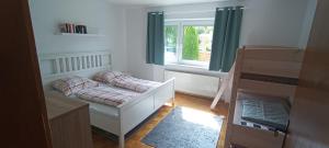 a small bedroom with a bed and a window at Ferienhaus Falkenstein mit wunderschönem Bergblick in Frauenau