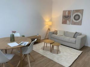 a living room with a couch and a table at Habicher Vienna Apartments in Vienna