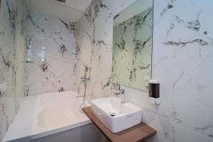 a white bathroom with a sink and a mirror at FabHotel Prime Ascent Star Inn in Mumbai +19 photos