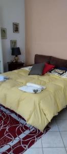 a bed with a yellow blanket on top of it at Ii Forno in Cossogno
