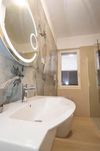 a bathroom with a white sink and a mirror at Lamarina case vacanza in Marina di Camerota +16 photos