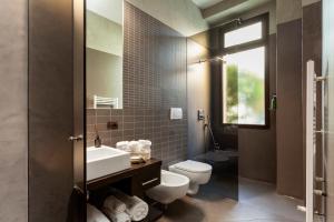 a bathroom with a white toilet and a sink at San Babila Suite in Milan +17 photos