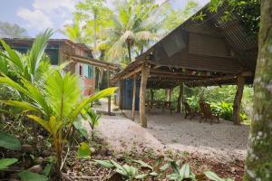 a building with chairs and a table in front of it at Nosara Samara, 2 BR, Jungle View, Fiber-Optic wifi in Nicoya +35 photos