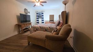 a living room with a couch and a bed at Grace Meadows in Tyler