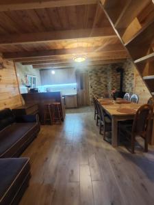 a dining room with a table and chairs at Chatka Podzawale in Bircza