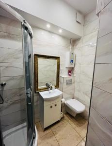 a bathroom with a sink and a toilet and a shower at Gdynia Abrahama 23 in Gdynia +21 photos