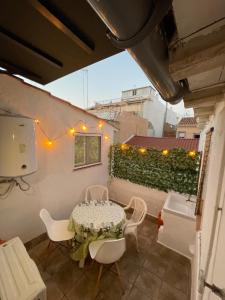 a patio with a table and chairs on a balcony at A vacation by the sea in Puerto de Sagunto