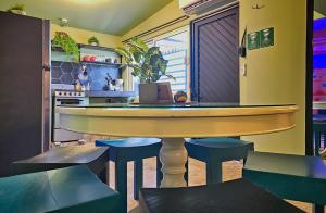 a bar with a table and some blue stools at Casa Arbol in La Paz