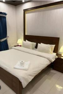 a bedroom with a large bed with a tray on it at Couple Friendly Guest House in Karachi