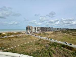 a highway with a beach and some buildings and the ocean at Studio Zilte Rust - Zeedijk Middelkerke in Mellet