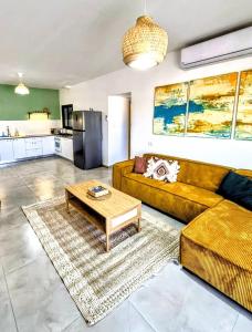 a living room with a couch and a coffee table at נחת רוח Nachat Ruach in Mitzpe Ramon