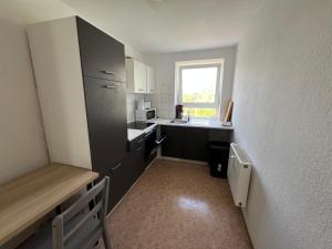 a small kitchen with a sink and a refrigerator at Monteurwohnung nähe Leuna, Halle und Leipzig in Braunsbedra