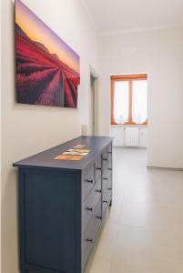 a room with a black cabinet and a painting on the wall at Casa Chanel in Rome