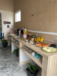 a buffet line with many plates of food on it at Suíte 1, Caminho do Mirante in Iguaba Grande +11 photos