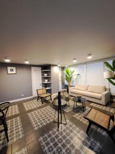 ein Wohnzimmer mit einem weißen Sofa und Tischen in der Unterkunft Departamento amoblado a pasos de ruta 5 con estacionamiento y WiFi in Coquimbo