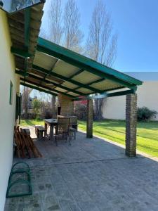 a patio with awning and a table and chairs at La Quinta de Areco in San Antonio de Areco +29 photos