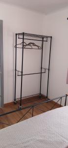 a metal shelf in a room with a bed at Casa da Aldeia in Figueiró dos Vinhos +24 photos