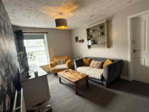 a living room with a couch and a coffee table at The Mansion House Hotel in Holbeach +35 photos