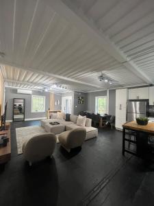 a large living room with a white couch and chairs at The Modern Metal Oasis in Woodstock +75 photos