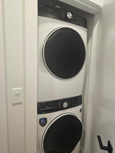 a microwave and a oven in a room at Modern Private Suite Fast WiFi Parking Quiet Stay in Prince George