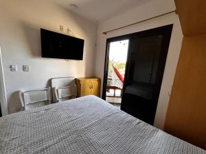 Katil atau katil-katil dalam bilik di Flat encantador com lazer