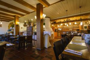 a restaurant with tables and chairs and a bar at Hotel Waibstadter Hof in Waibstadt