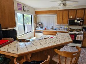 a kitchen with a table and a counter top at Cat & Coffee Prime City Access - Room 1 in San Diego +2 photos