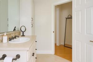 a white bathroom with a sink and a mirror at The Heart Of Hollywood Hills in Los Angeles +2 photos