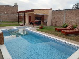 a swimming pool in the backyard of a house at Duplex Mi Lar in Termas de Río Hondo +10 photos