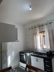 a kitchen with a sink and a stove top oven at Cozy house near Vila Aurora Station in Sao Paulo