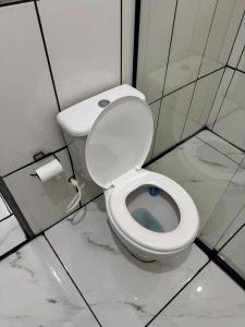 a bathroom with a white toilet in a stall at Cozy house near Vila Aurora Station in Sao Paulo