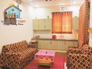 a living room with two couches and a table at Islamabad Tinny Happy Family Home in Islamabad